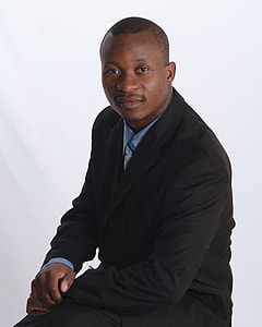 man in black suit photo thumbnail