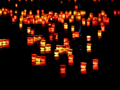 tealight on river photo during daytime thumbnail