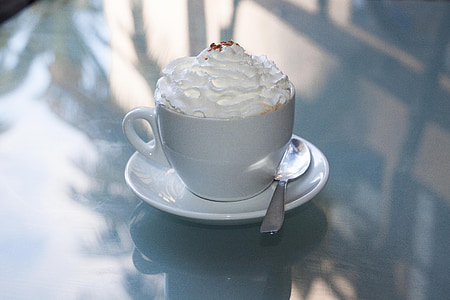 white ceramic teacup on saucer with silver spoon thumbnail