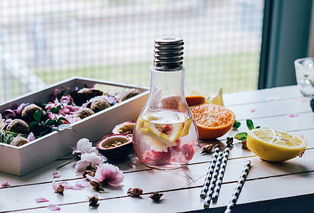 pink and yellow flowers inside clear glass bulb bottle thumbnail