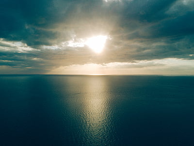 calm body of water under gray and white cloudy sky thumbnail