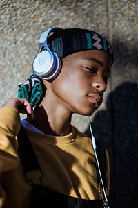 boy wearing yellow sweater listening to music thumbnail