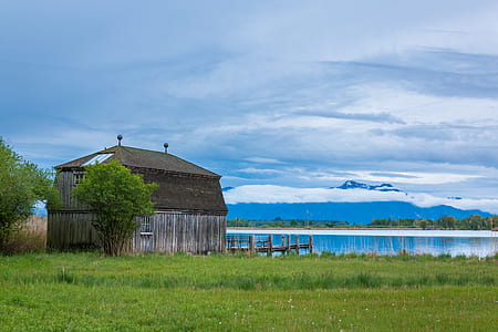 house on farm beside body of water thumbnail