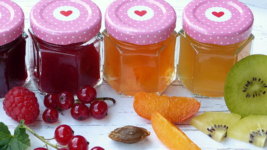 several fruit juices inside clear glass jars thumbnail