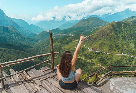 woman in staircase in front of view of mountain thumbnail