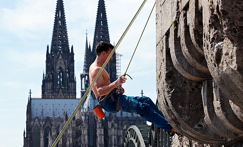 man climbing rock formation thumbnail