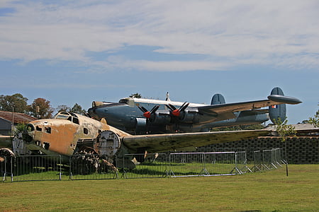 vintage plane placed on grass field thumbnail