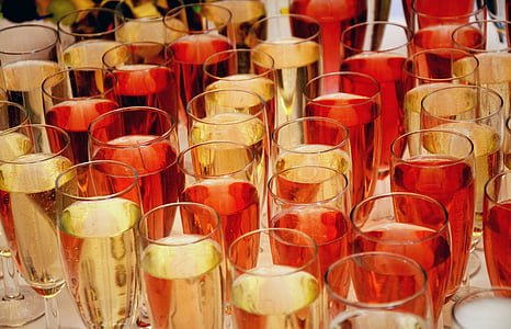 clear champagne flute glasses filled with red and brown liquids thumbnail