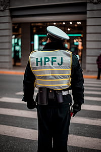 man standing on pedestrian lane near storefront during daytime thumbnail