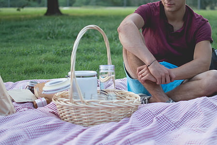 photo of man sitting in pink cloth near wicker basket thumbnail