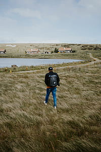 person walking on grass field thumbnail