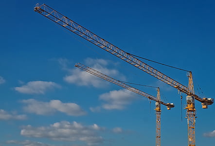 two crane tower under clear blue sky thumbnail