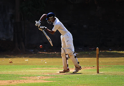 person wearing sport gear equipment on green field during daytime thumbnail