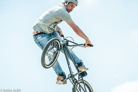 man performing stunts using black BMX bike thumbnail