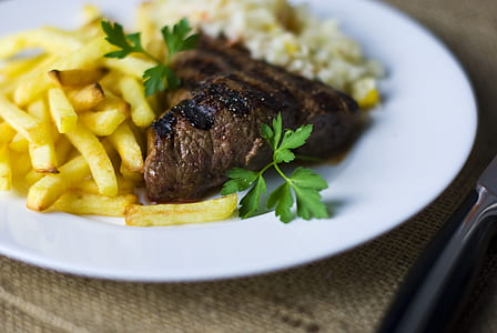 selective focus photography of grilled meat with potato fries thumbnail