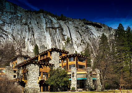 brown and gray house near gray mountain during daytime thumbnail