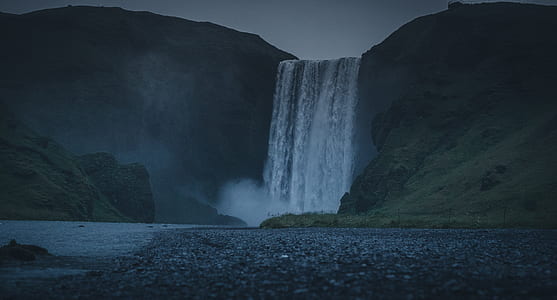 landscape photo of waterfalls under cloudy sky thumbnail