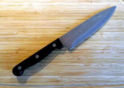 black handled knife on brown wooden surface thumbnail