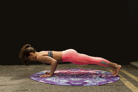 woman doing push-up on round mat thumbnail