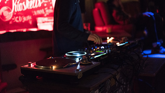 man operating DJ controller thumbnail