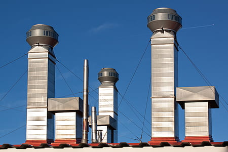 exhaust vents under blue sky during daytime thumbnail