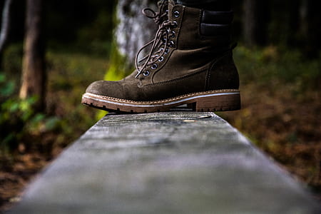 brown work boot on gray concrete bar during daytime thumbnail