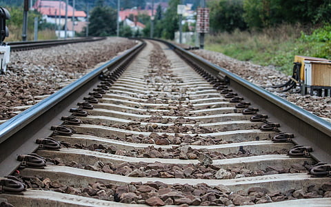 gray metal train rail at daytime thumbnail