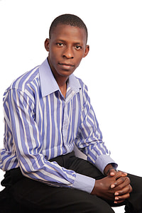 man wearing purple stripe dress shirt and black dress pants while sitting thumbnail