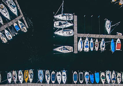 aerial photography of assorted-color boat lot on body of wate thumbnail