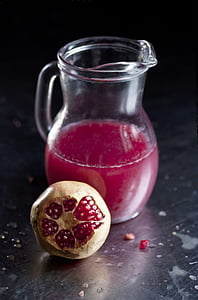 clear glass pitcher and pomegranate thumbnail