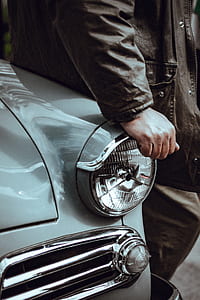 person leaning on classic teal car thumbnail