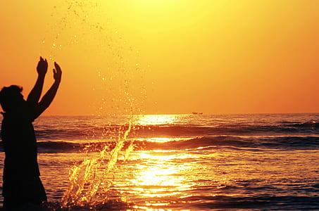silhouette photo of man on seashore thumbnail