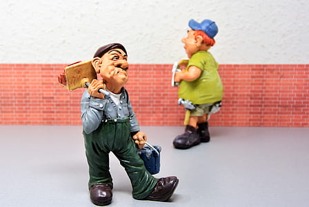 two man figurines beside wall thumbnail