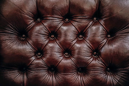 close-up photo of tufted brown leather cushion thumbnail