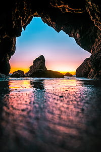 calm water under cave during golden hour thumbnail