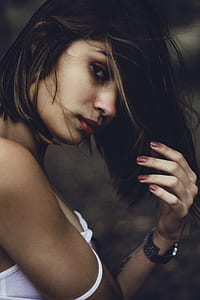 woman raising left hand and facing to the right thumbnail