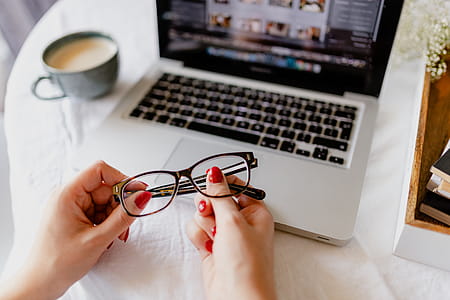 A woman works at a desk with a laptop and a cup of coffee thumbnail