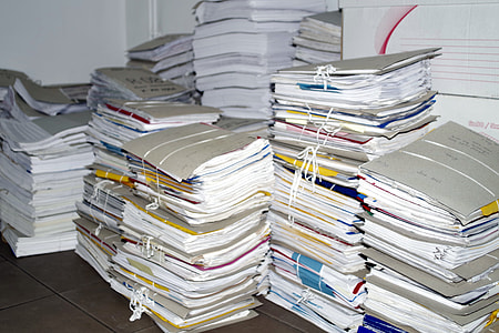 white printer paper lot on brown tiles thumbnail
