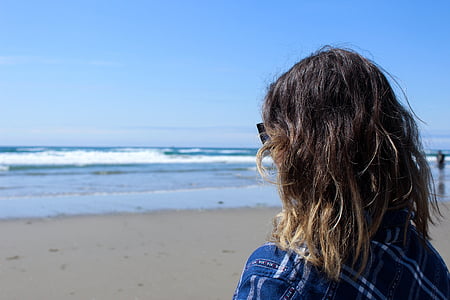 woman standing near sea water taken at daytime thumbnail