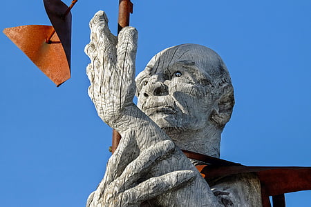 statue of man holding left hand at daytime thumbnail