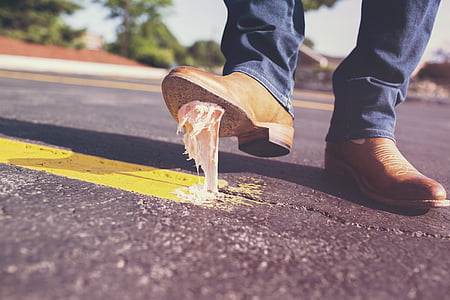 person stepped on white gum near roadside during daytime thumbnail