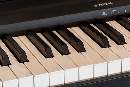 black Yamaha electric keyboard on black surface thumbnail