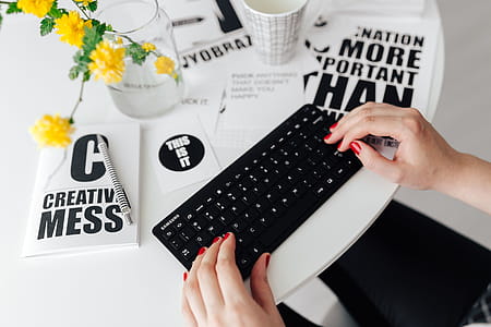 Female hands typing on the remote wireless computer keyboard thumbnail