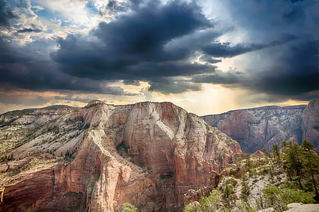 photo of brown mountains surrounded by trees thumbnail