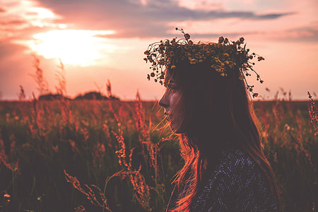 woman at the field wearing floral headdress during day thumbnail