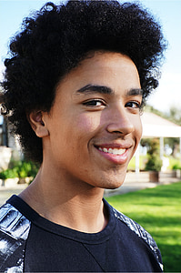 man wearing black and white shirt while smiling thumbnail