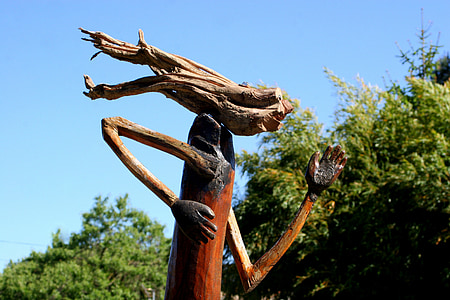 brown wooden statue near tre thumbnail