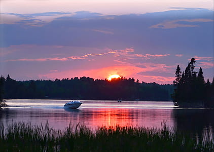 white boat on body of water during sunset thumbnail