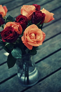 red and pink rose flowers in clear glass vase thumbnail