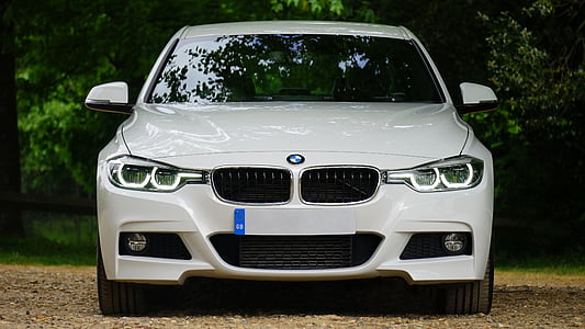 white BMW vehicle park during daytime thumbnail